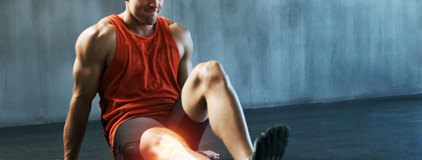 Man stretching calf with foam roller